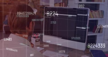 A man sitting at a desk and watching coding data processing on a computer screen. Global business finances connections and digital interface concept digitally generated video.