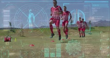 Animation of screen with biological data over diverse male soccer players during training. Sport, soccer, durability and technology concept digitally generated video.