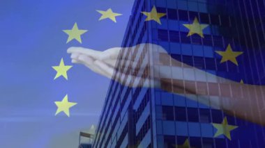 Hand holding globe with flags animation over European Union stars and building. Globalization, international, unity, collaboration, diplomacy, diversity