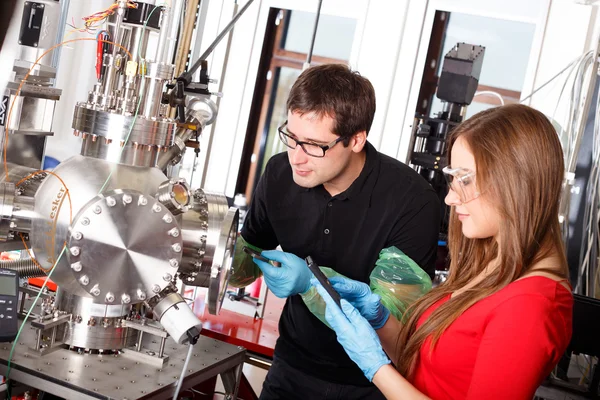 Scientists working with laser deposition chamber — Stock Photo, Image