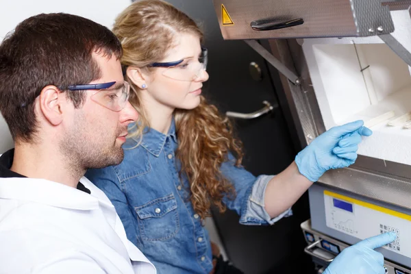 Científicos investigan en un ambiente de laboratorio — Foto de Stock