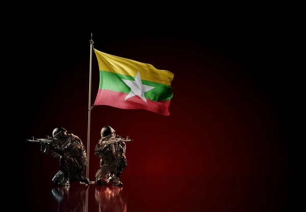 Concept of military conflict with soldier statues and waving national flag of Myanmar. Illustration of coup idea. Two guards defending the symbol of country against red wall