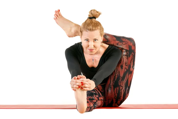 Sport fitness vrouw doen yoga oefeningen, zeer hard geavanceerde pose met been achter hoofd, volledige lengte portret geïsoleerd op witte achtergrond Stockafbeelding