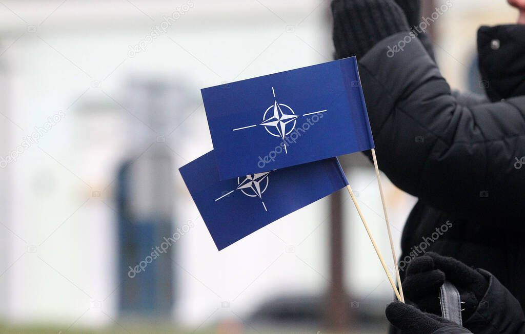 NATO flag in hand, symbol