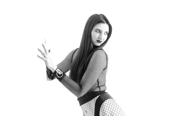 A striking portrait of a powerful woman in dark minimalist fashion. Strong pose, fishnet outfit, artistic fetish aesthetic, modern editorial energy and confident feminine dominance.
