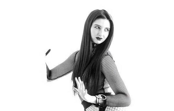 A striking portrait of a powerful woman in dark minimalist fashion. Strong pose, fishnet outfit, artistic fetish aesthetic, modern editorial energy and confident feminine dominance.