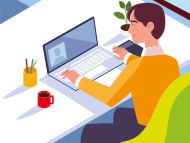 Dizüstü bilgisayarlı kahve fincanı ve çalışma masasında bitki yetiştiren bir adam.