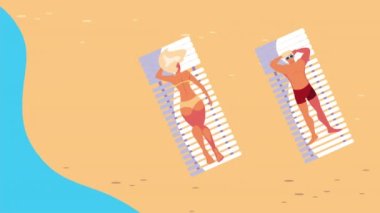 Genç çift kumsalda güneşleniyor.