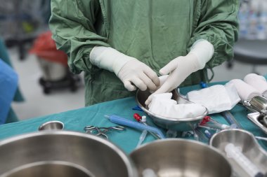 scrub nurse prepare medical instruments for open heart surgery clipart