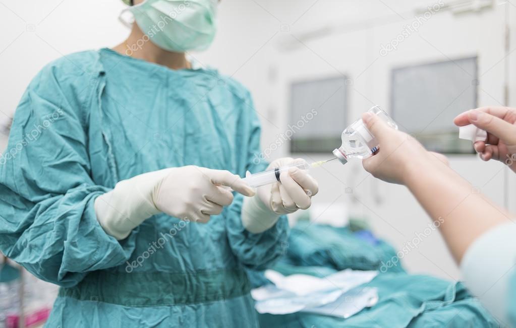 scrub nurse preparing medical solution