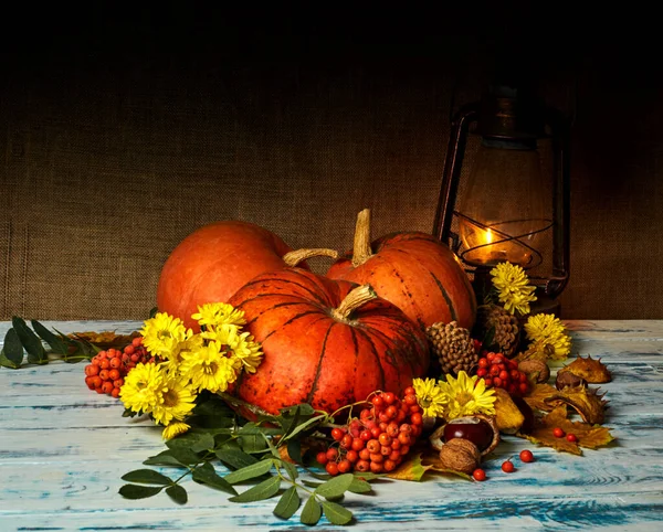 pumpkins, autumn leaves kerosene lamp