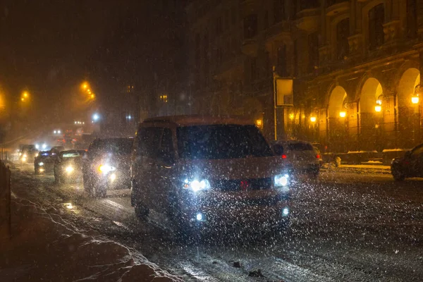 Winter snow storm. Traffic jam at night. Car blurred at the street. Stock Picture