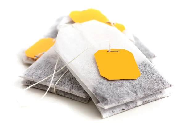 Classic yellow tagged tea bags. — Stock Photo, Image