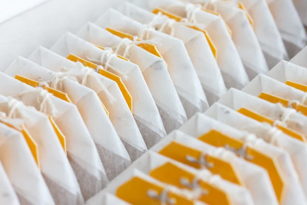 Detail of packed yellow tagged tea bags — Stock Photo, Image