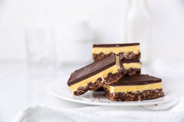 A plate of Nanaimo bars - a traditional Canadian dessert clipart