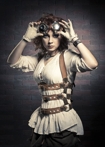 Redhair girl with steampunk goggles