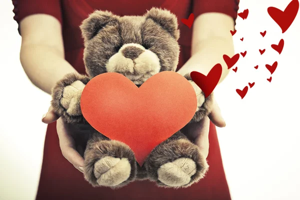 Female hands holding magical heart and soft toy. — Stock Photo, Image