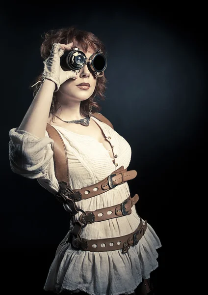 Steampunk woman looking over her goggles — Stock Photo, Image