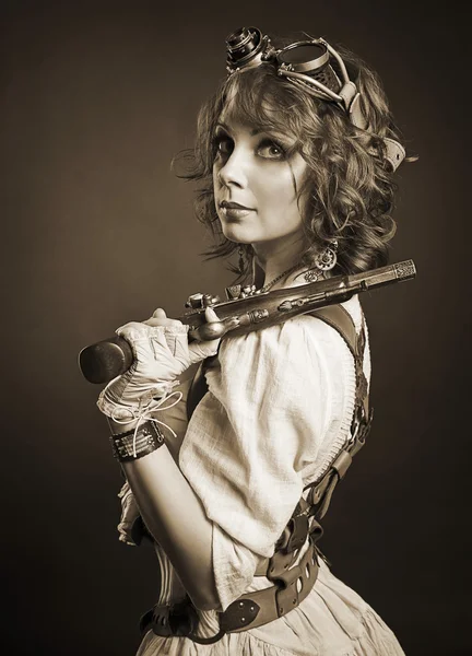 Beautiful redhair steampunk girl with gun looking at camera. Old — Stock Photo, Image