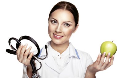 Yeşil elma ve stethosco tutarak çekici mutlu kadın doktor