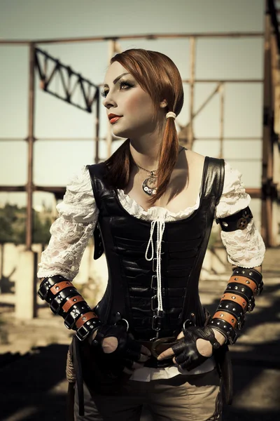 Attractive young l woman in leather corset posing outdoors. — Stock Photo, Image