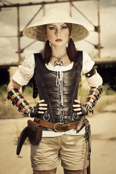 Attractive young beautiful woman in leather corset posing on the — Stock Photo, Image