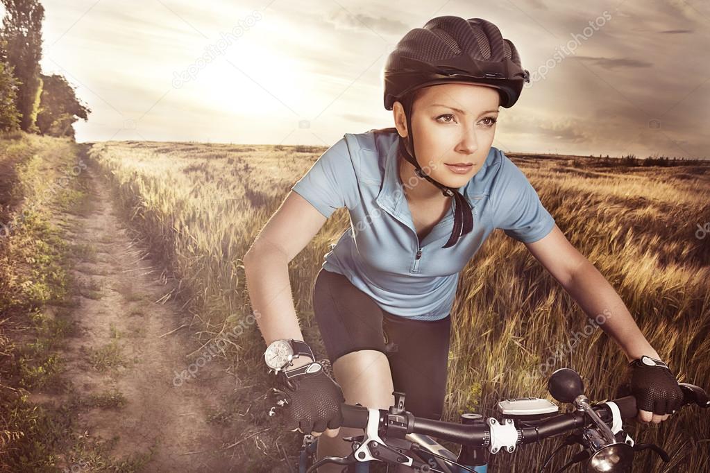 Attractive purposeful in sports equipment active girl riding a r