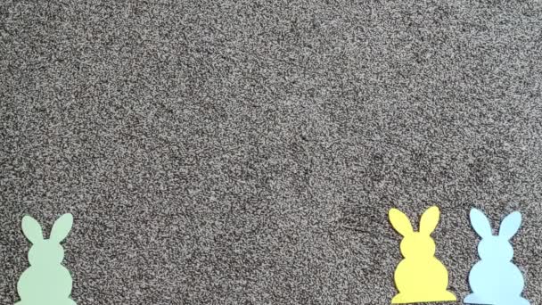 Stop motion colorful paper Easter bunnies gradually fill the screen. — Stock Video