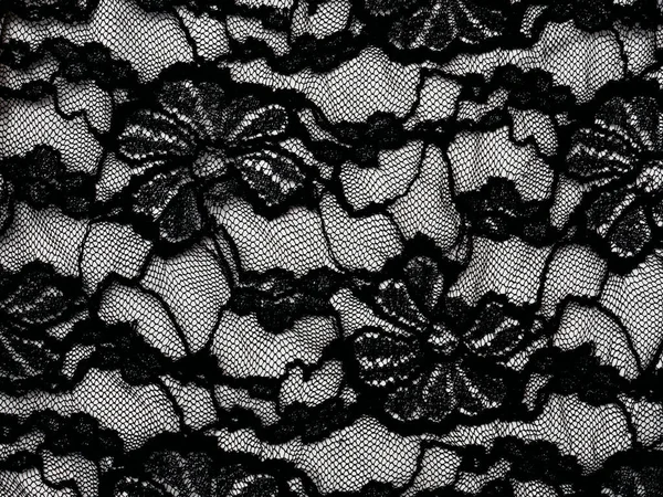 Abstract abito femminile bianco e nero come sfondo. Tessuto in pizzo con fiori. Progettazione della decorazione. Concetto lussuoso e sexy. Stile vintage — Foto Stock