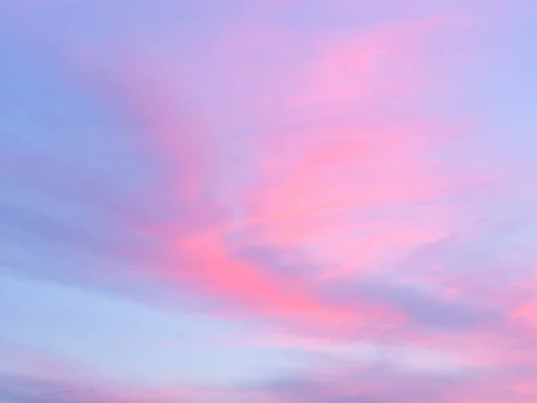 Soft, fluffy and colorful cloud formation. Abstract idyllic pink and blue sky. Blur background texture of colorful sunset clouds. Twilight sky. Fresh air, weather concept