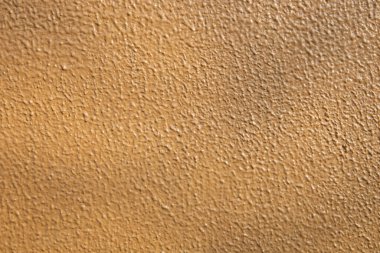 Arka plan kullanımı için açık kahverengi beton duvar dokusu ve gölge. Turuncu kabataslak fon. Stucco yüzeyi. Soyut model. Yağlı alçıdaki boya dokusu. Soyut sanat yaratıcı arkaplan.
