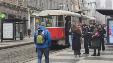 Prag, Çek Cumhuriyeti 27 Şubat 2026: Klasik kırmızı tramvay 4K yavaş çekimde şehir kavşağında kameraya yaklaşırken çekildi. Bu 4K hisse senedi görüntüsü herhangi bir Prag editör projesi için tam olarak ihtiyacınız olan şey.
