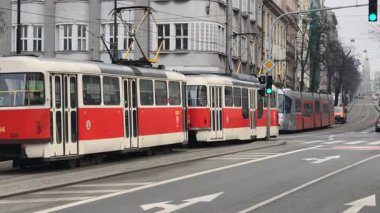 Prag, Çek Cumhuriyeti 27 Şubat 2026: Klasik kırmızı tramvay 4K yavaş çekimde şehir kavşağında kameraya yaklaşırken çekildi. Bu 4K hisse senedi görüntüsü herhangi bir Prag editör projesi için tam olarak ihtiyacınız olan şey.