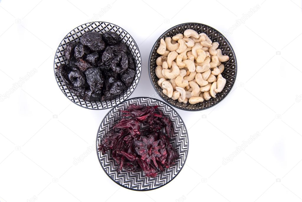 Group of plums, hibiscus and cashews