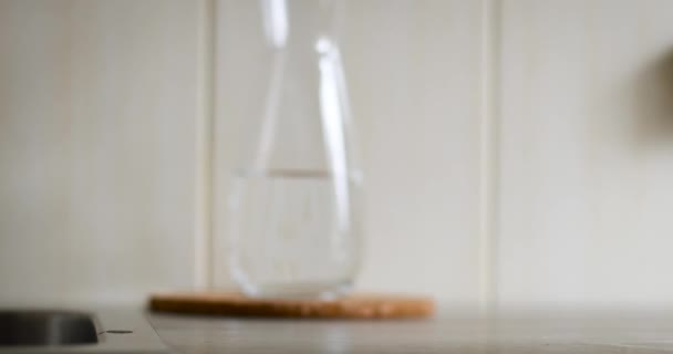 Vrouw hand zet een glas schoon water op tafel — Stockvideo