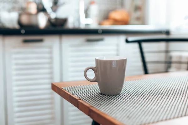 Hot cup of tea or coffee, cocoa on wood table in kitchen background. Good morning wake up concept