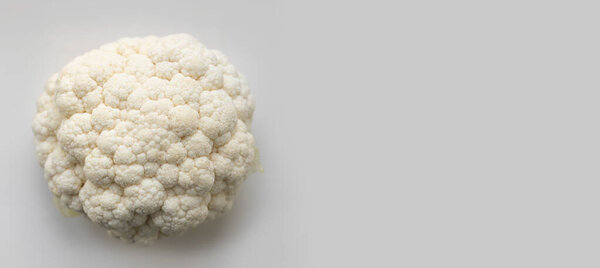 Fresh cauliflower on a gray background with copy space. Top view, flat lay, horizontal banner