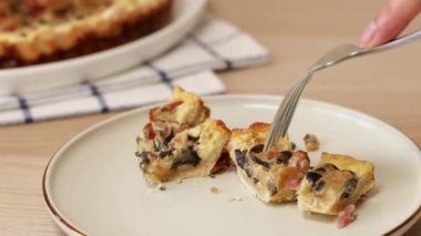 Yakın plan erkek elleri, ev yapımı pastırmalı, mantarlı ve soğanlı çatallı turta alır. Tavuklu tart. Tavuklu pasta.