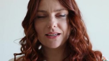 Kameraya hava öpücüğü gönderen gülümseyen bir kadının portresi.