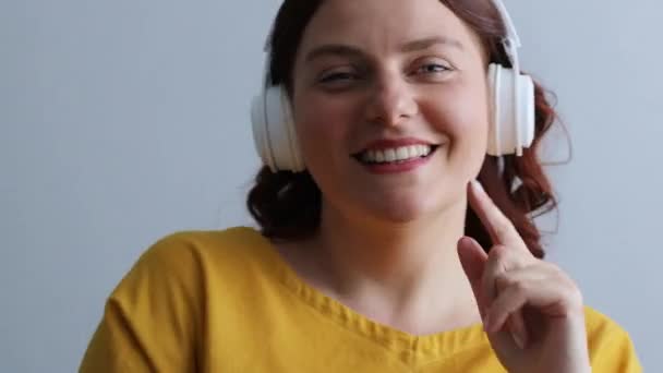 Mujer feliz escuchando música con auriculares — Vídeos de Stock