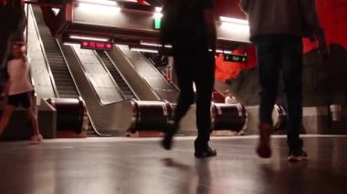 Underground Radhuset subway station hallway tunnel with escalator. Crowd of people on escalator going up to subway station