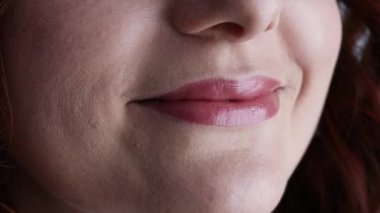 Close up cropped face of positive adorable cute lovely girl licking lips