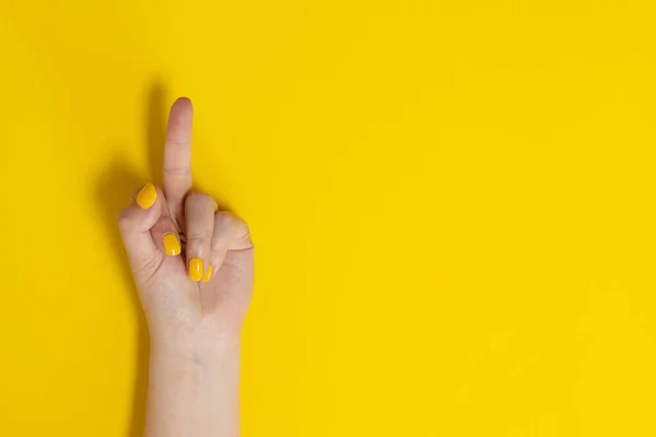 Female Hands Showing Middle Fingers Gesturing Fuck Yellow Background — Stok fotoğraf