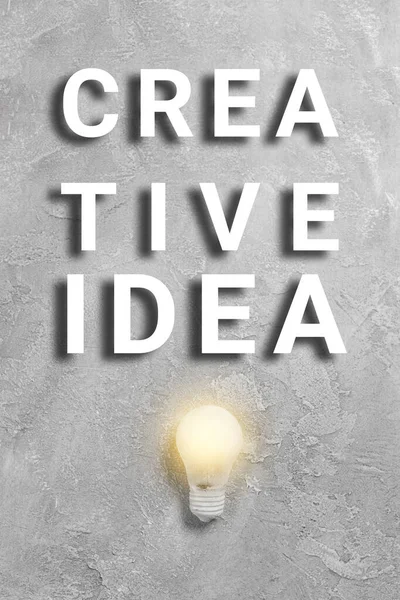Texto Idea Creativa Con Bombilla Brillante Sobre Fondo Gris Cartel — Foto de Stock