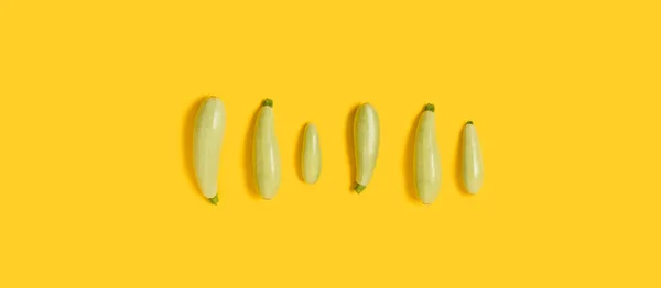 Flat lay composition with fresh organic vegetable marrow on yellow color background. Top view. Flat lay pattern, banner. — Stock Photo, Image