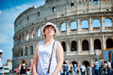 Woman tourist on the background of the Colosseum in Rome
