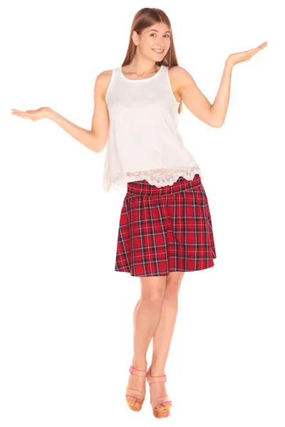 Girl in a vest and skirt behind white wall — Stock Photo, Image