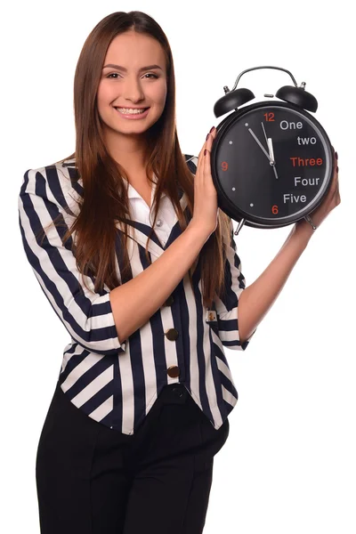 Девушка из офиса показывает часы на белом фоне — стоковое фото