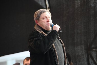 Politician Grigory Yavlinsky on the stage of opposition rally clipart