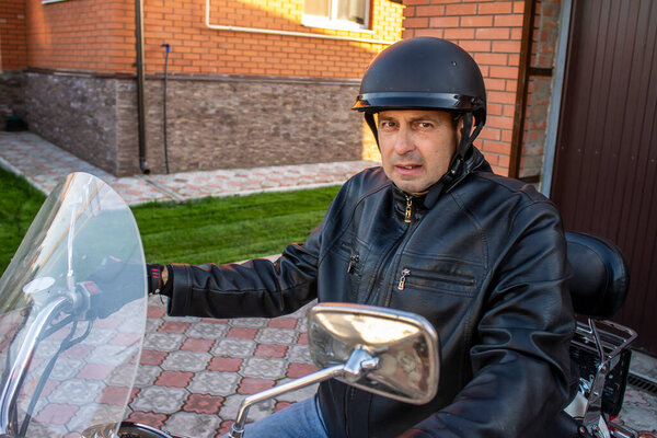 Motorcycle man in jacket and helmet, biker